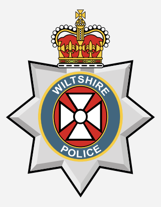Wiltshire Police badge with a crown on top and a central red and white emblem.
